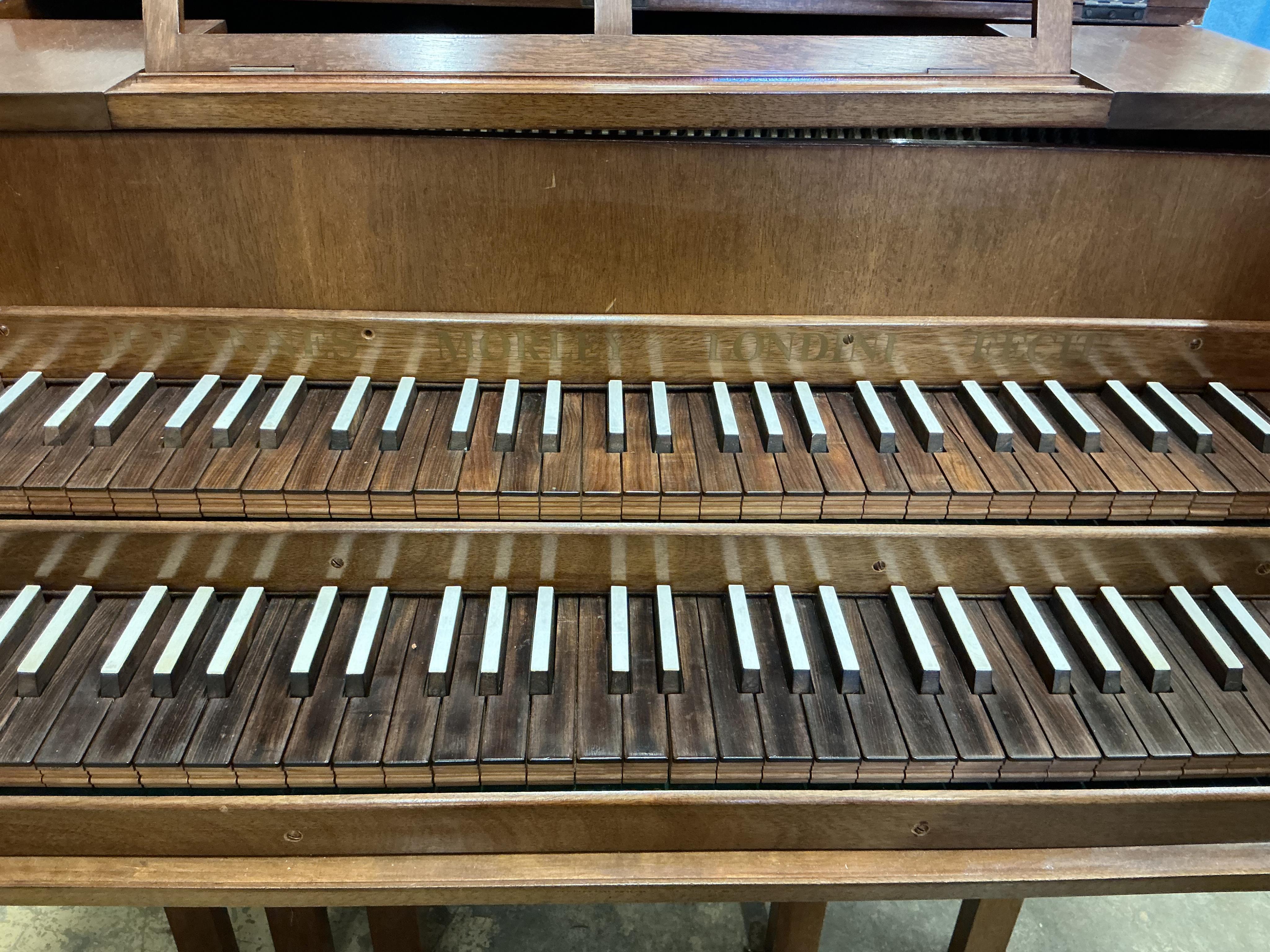 A 1960s two manual harpsichord by John Morley, 61 note compass on each manual with coupler, one stop and three pedals, in mahogany veneer, signed to the soundboard and above the manuals, serial number 1052, length 207cm